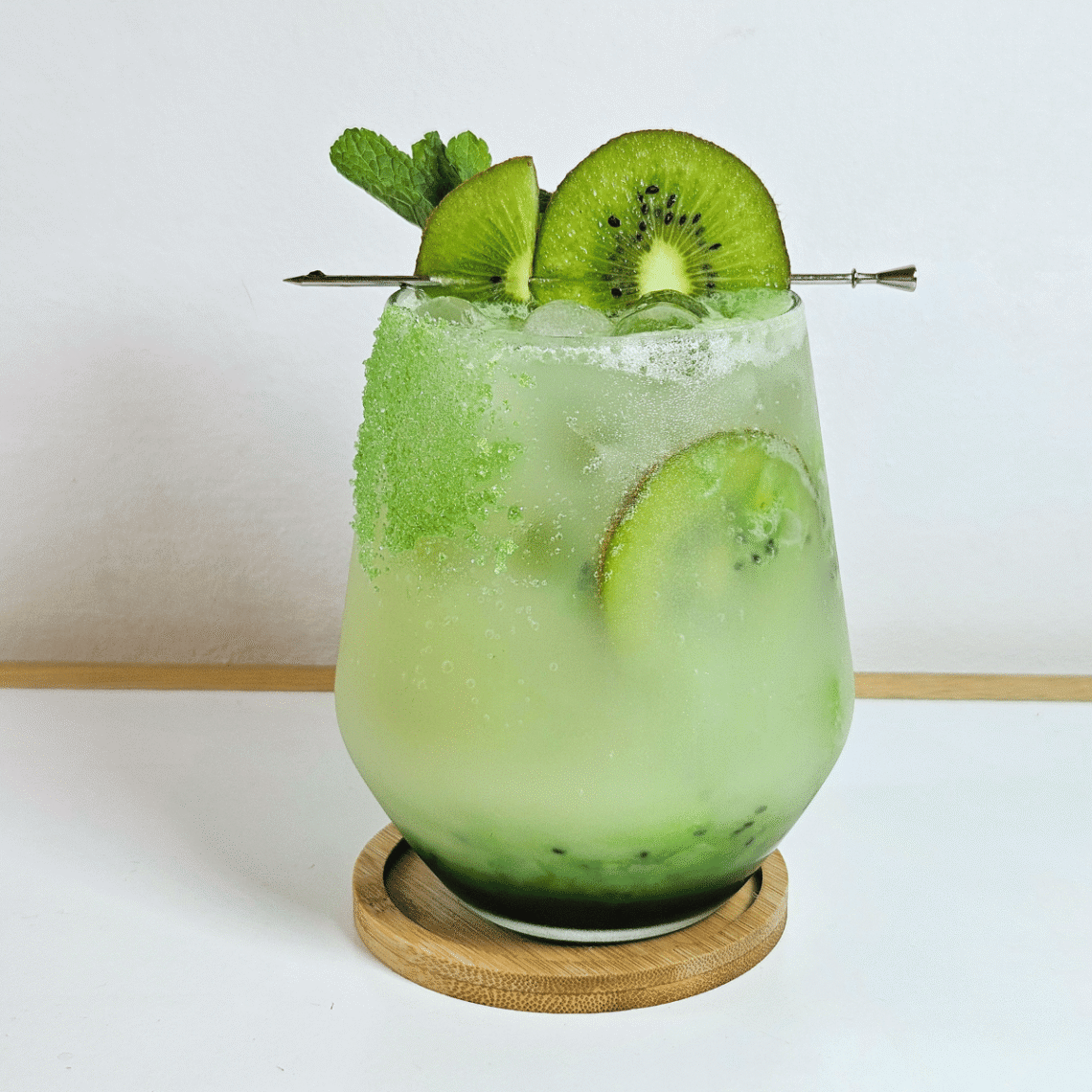 Kiwi Yakult Drink garnished with kiwi slices and mint leaves
