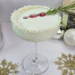 White Christmas Colada Mocktail Garnished with Cranberries and rosemary