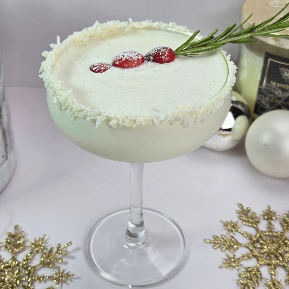 White Christmas Colada Mocktail Garnished with Cranberries and rosemary
