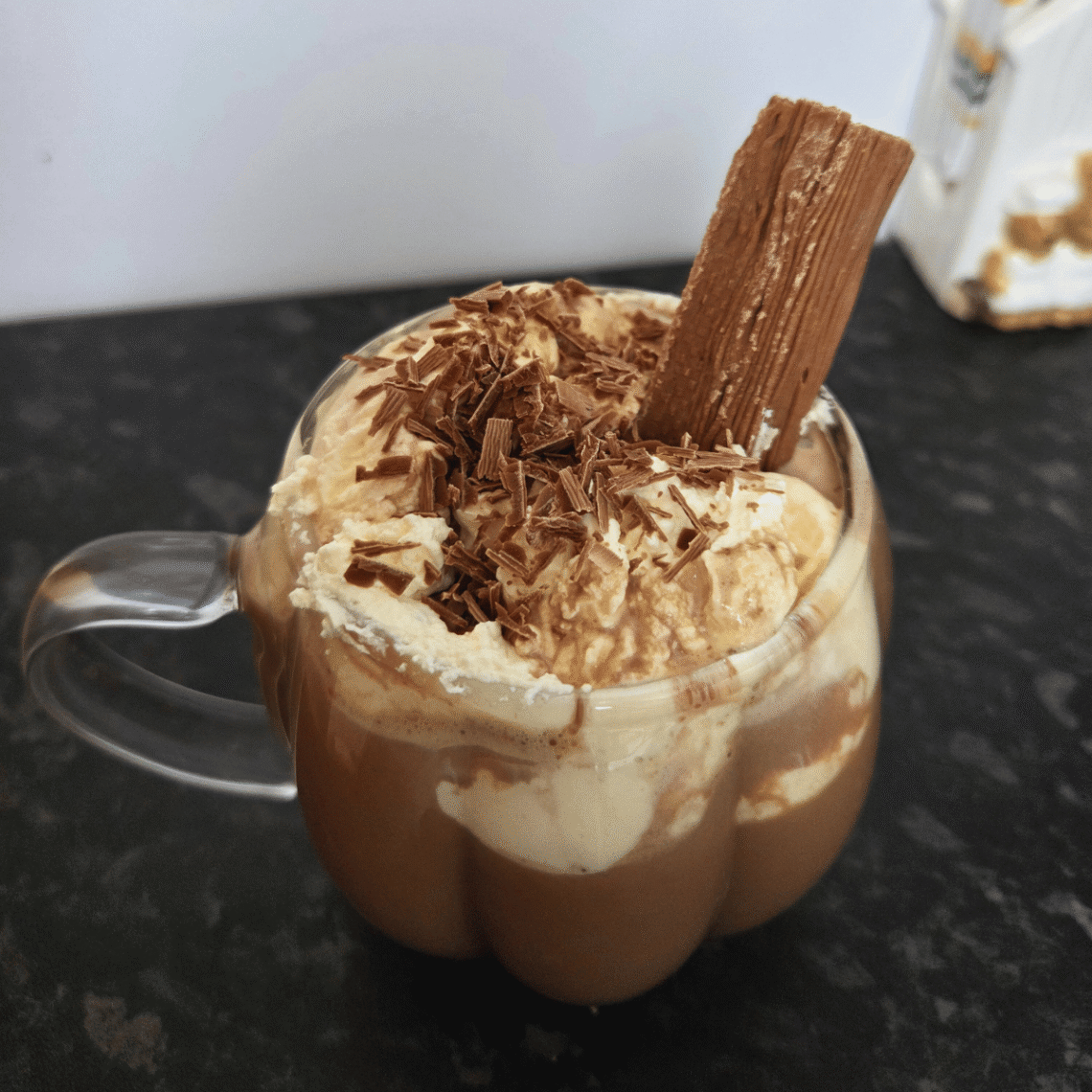 hot chocolate topped with whipped cream and a cadbury flake