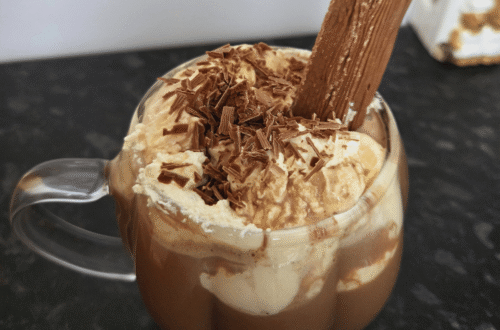 hot chocolate topped with whipped cream and a cadbury flake