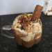 hot chocolate topped with whipped cream and a cadbury flake