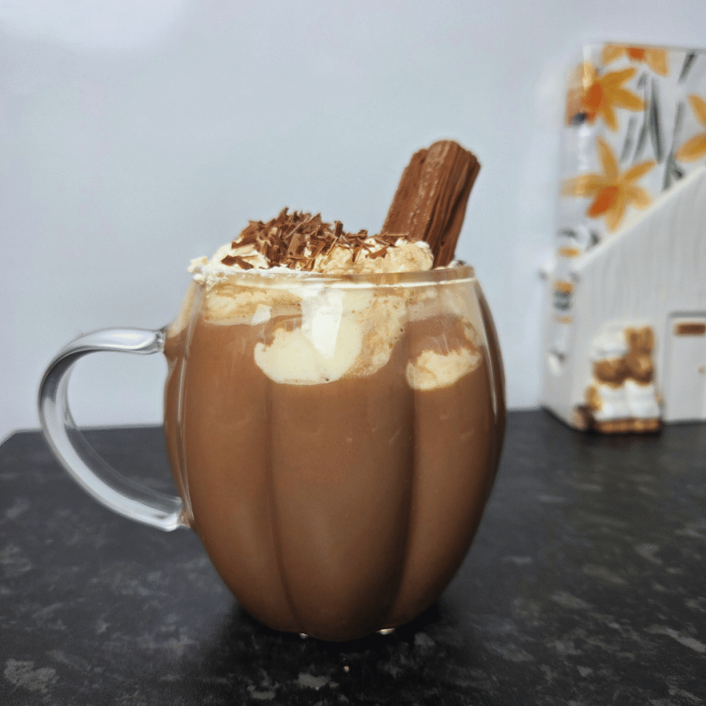 hot chocolate topped with whipped cream, chocolate shavings and cadbury flake