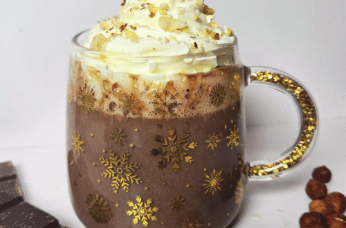 Nutella hot chocolate topped with whipped cream and chopped hazelnuts